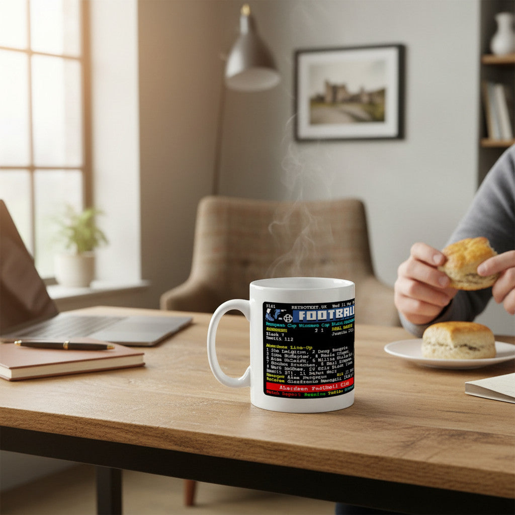 Retrotext ceramic coffee mug featuring an Aberdeen 1983 European Cup victory teletext design on a wooden desk