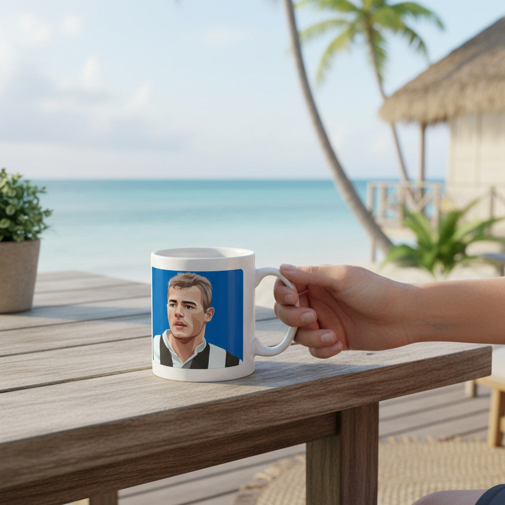 Retrotext ceramic mug featuring an illustration of Alan Shearer in a Newcastle United kit on a beachside table