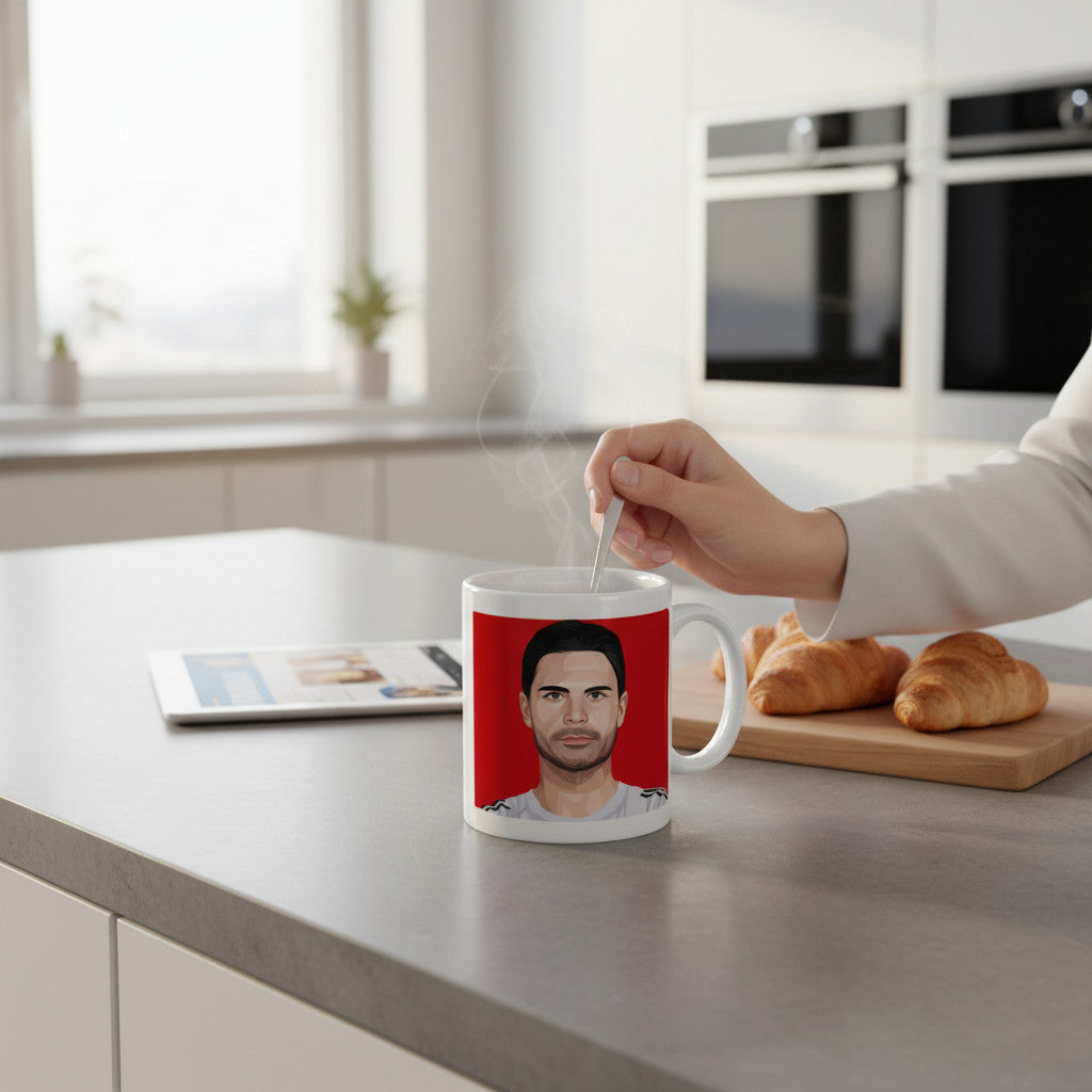 Retrotext ceramic coffee mug featuring a Mikel Arteta graphic on a red background, held in a bright kitchen setting.
