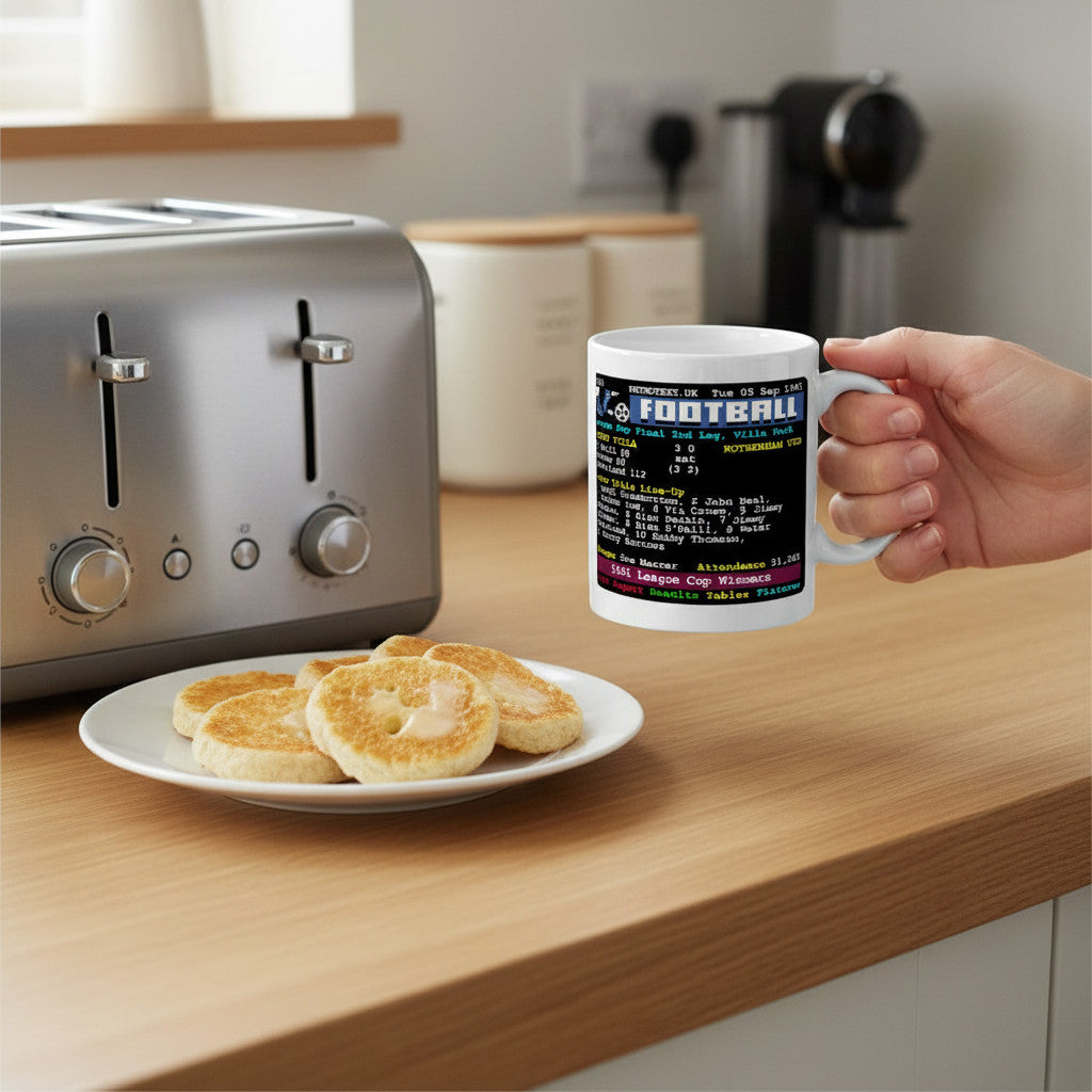 Retrotext Aston Villa 1961 League Cup Winners teletext design mug held in a hand near a toaster and plate of crumpets
