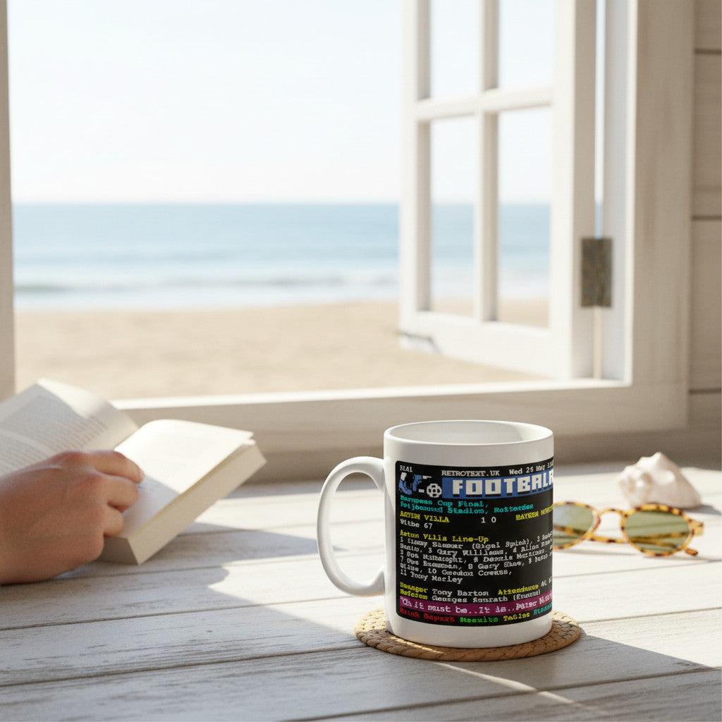 Retrotext Aston Villa 1982 European Cup final Teletext design mug on a wooden table by a sunny beach window.