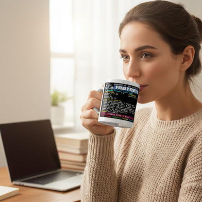 Woman drinking from a Retrotext Aston Villa 7-2 victory teletext mug while sitting at a desk with a laptop.
