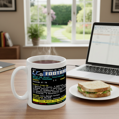 Retrotext 11oz glossy white mug featuring a 2002 Brazil World Cup final teletext design on a wooden desk