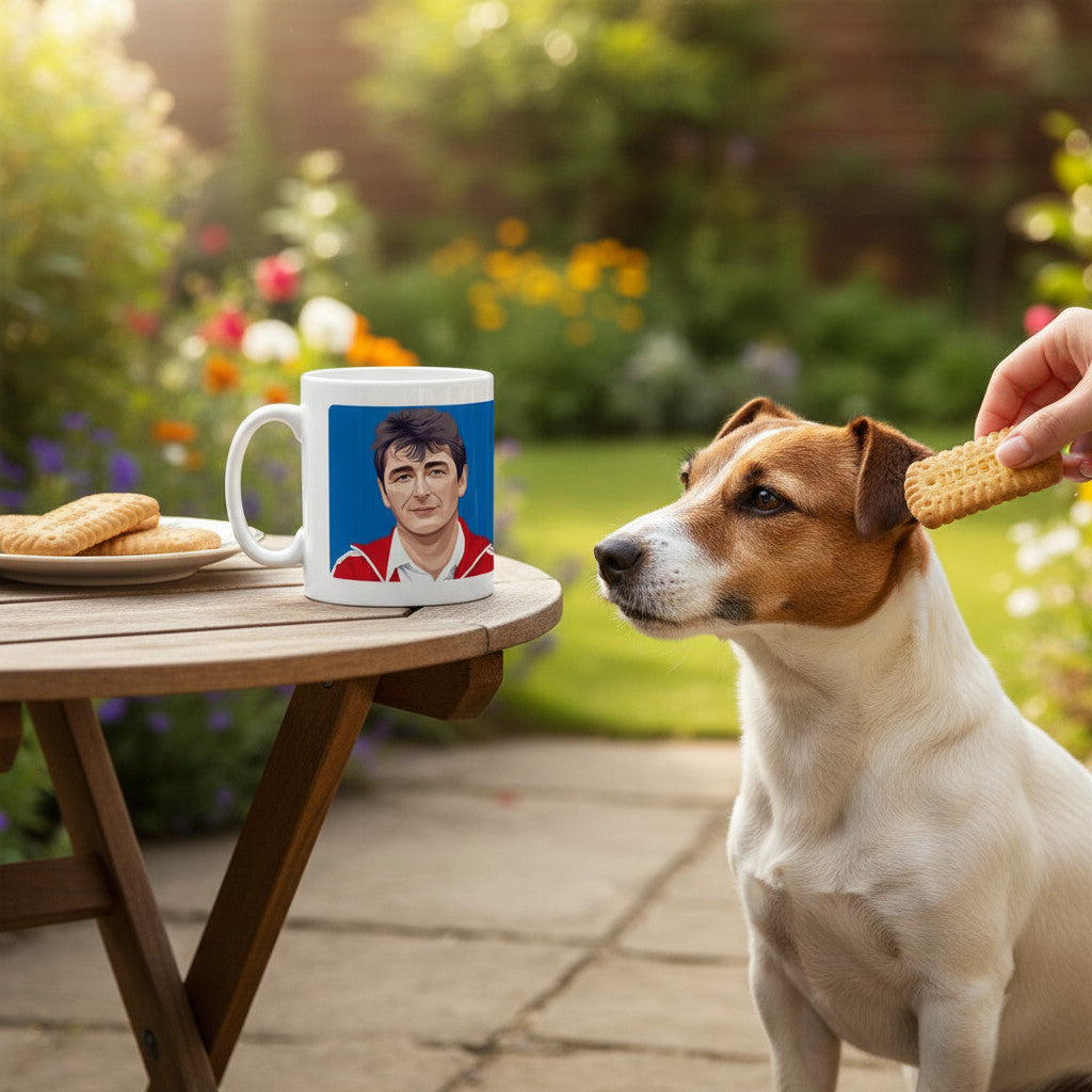 Retrotext white ceramic mug featuring a Brian Clough illustration, sitting on a garden table next to a Jack Russell.