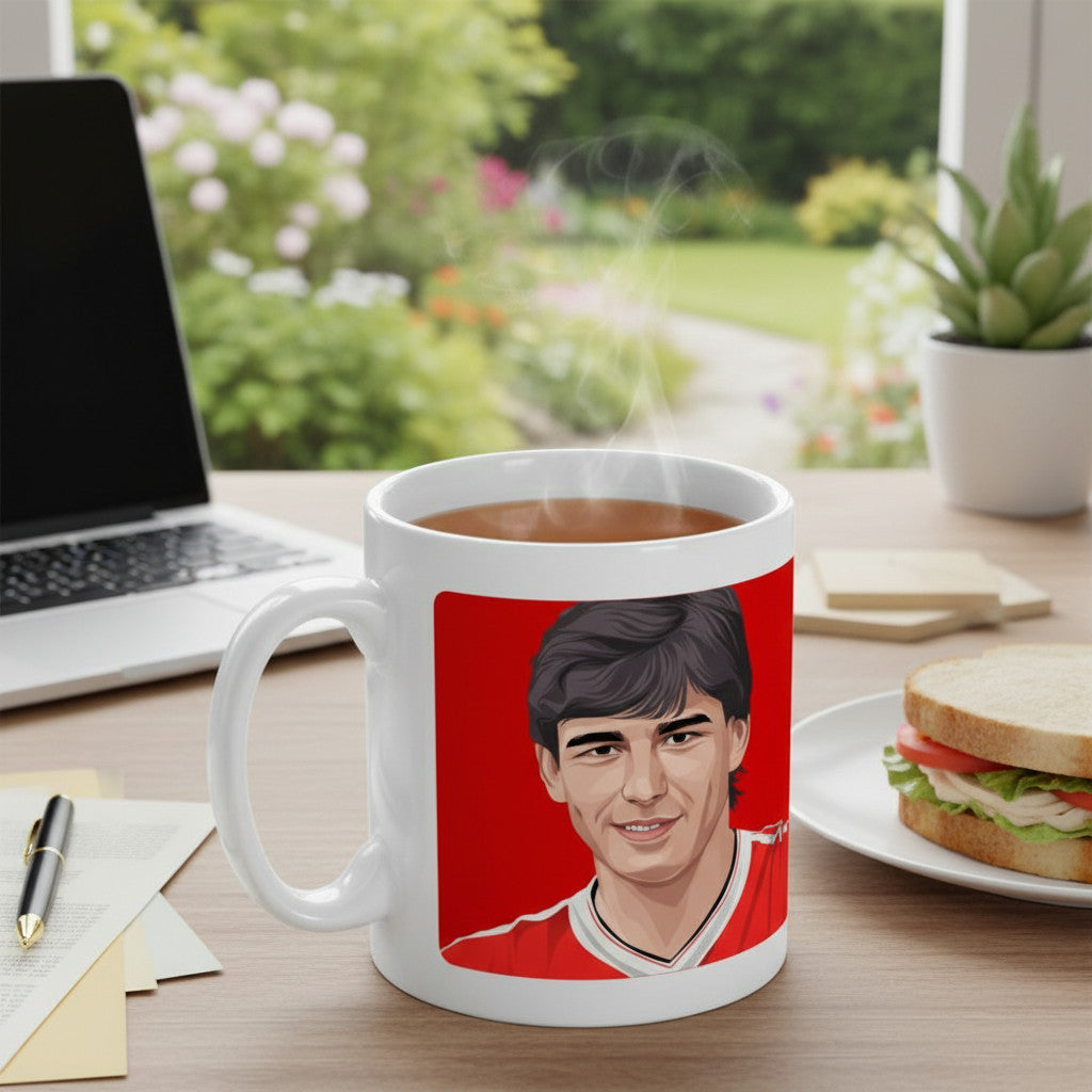 Retrotext 11oz glossy white mug featuring a graphic illustration of Bryan Robson in a Manchester United kit.