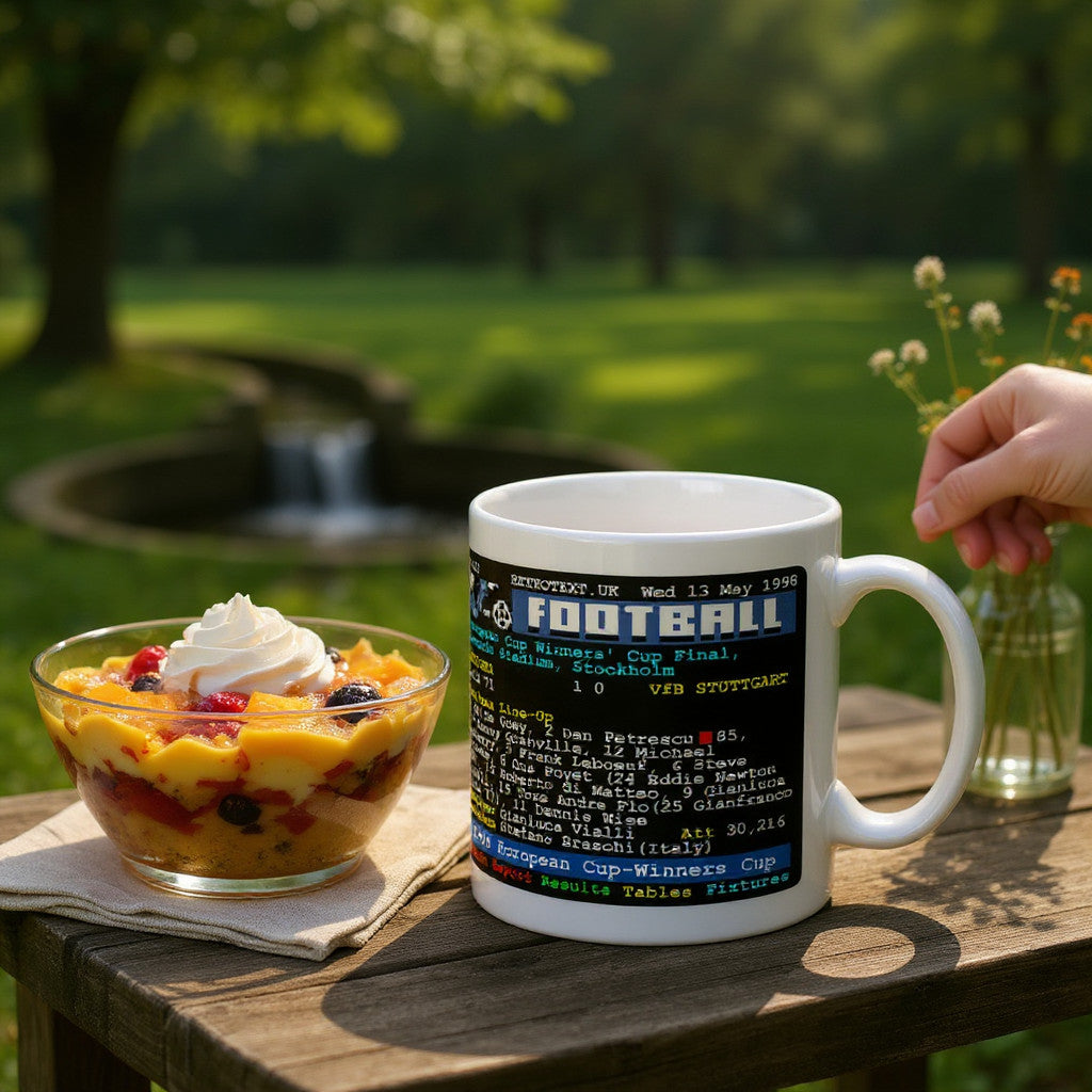 Retrotext Chelsea 1998 European Cup-Winners Cup Final teletext ceramic mug on a wooden table with a fruit dessert.