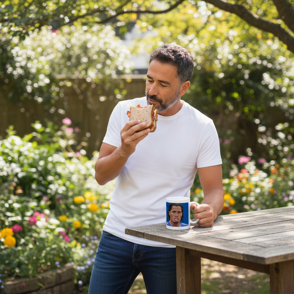 Man in white t-shirt eating a sandwich outdoors with a Retrotext Chelsea Didier Drogba FA Cup winners ceramic mug