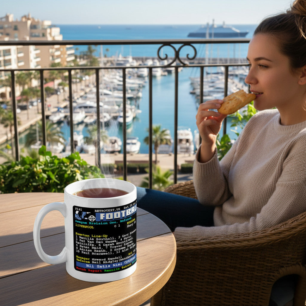 Retrotext Everton 1984 Graeme Sharp teletext ceramic mug on a balcony table with a woman eating a pastry