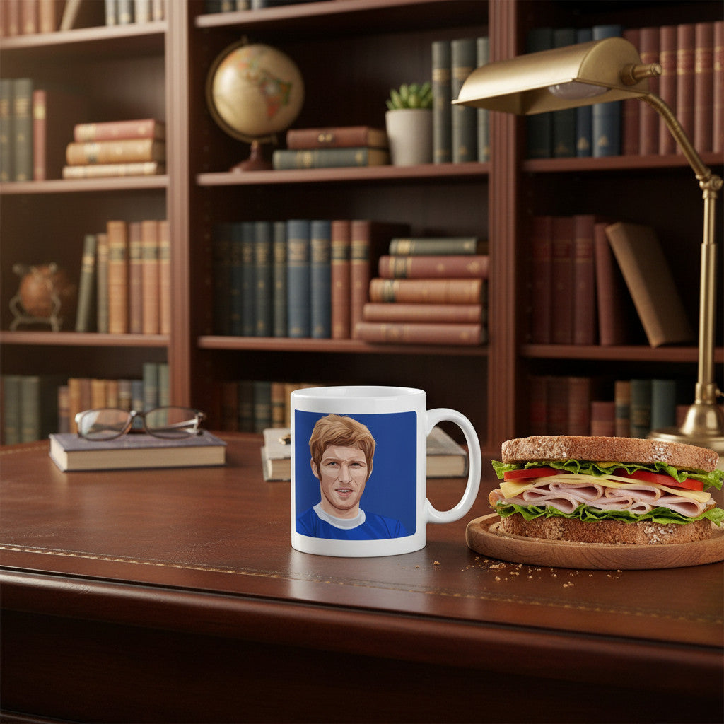 Retrotext Everton 1967 Alan Ball mug featuring a portrait illustration on a glossy white ceramic surface on a desk.