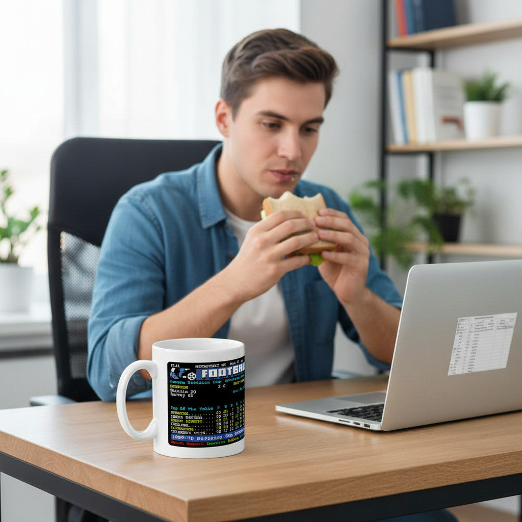 Retrotext Everton 1970 Division One Champions Colin Harvey teletext design mug on a desk next to a laptop