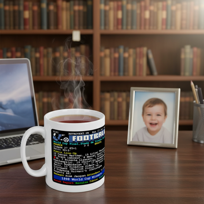 Retrotext 11oz glossy white mug featuring a 1998 France World Cup final teletext score design on a wooden desk