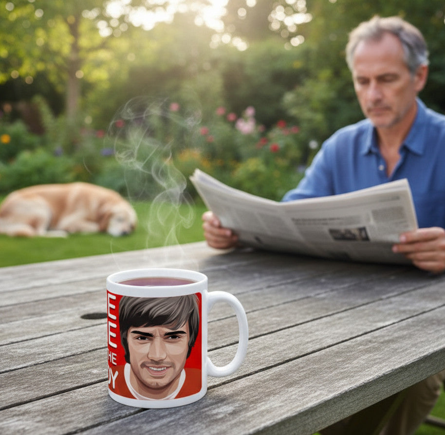 Retrotext Manchester United George Best Belfast Boy ceramic mug on a wooden table with a man reading in the background
