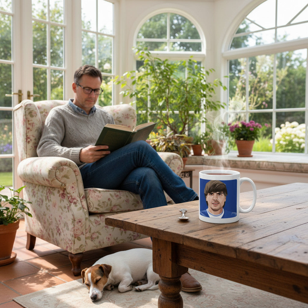 Retrotext ceramic mug featuring a Graeme Sharp 1984 Everton teletext design, sitting on a wooden table in a sunroom.