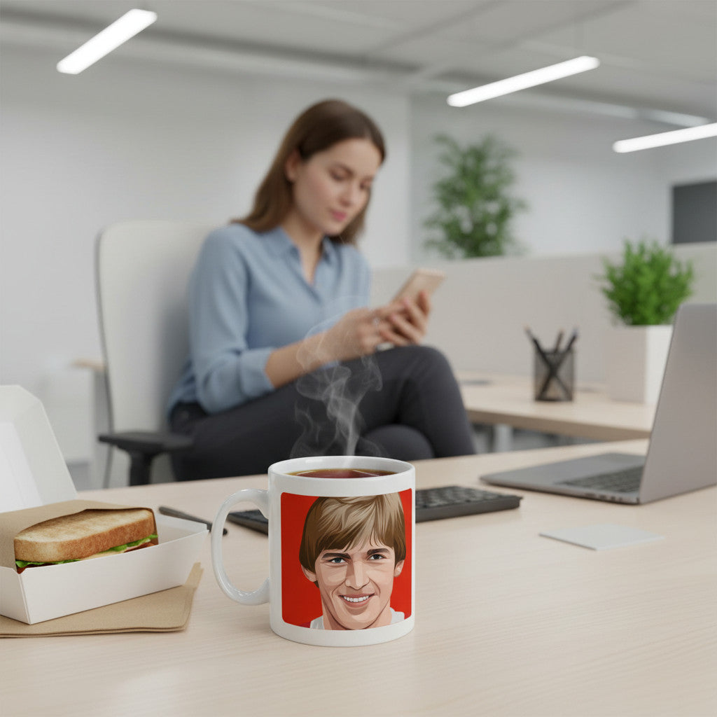 Retrotext ceramic mug featuring Kenny Dalglish on a red background, sitting on an office desk with a sandwich.