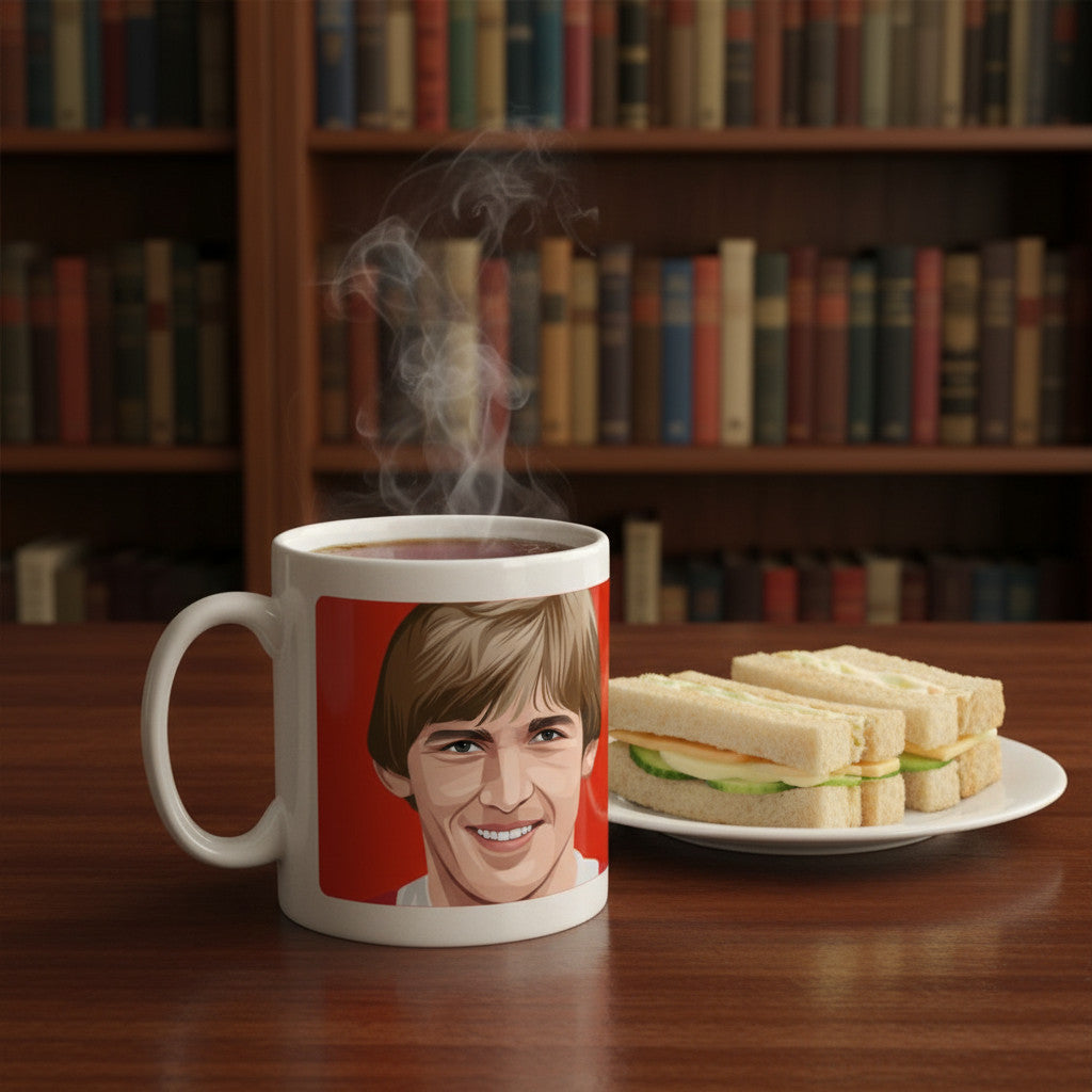 Retrotext ceramic mug featuring a Kenny Dalglish graphic on a red background, steaming with coffee next to sandwiches.