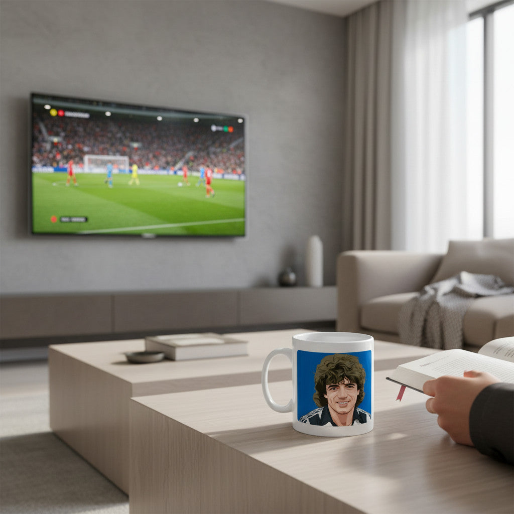 Retrotext 11oz glossy white mug featuring a Kevin Keegan Newcastle United 1982 debut illustration on a coffee table