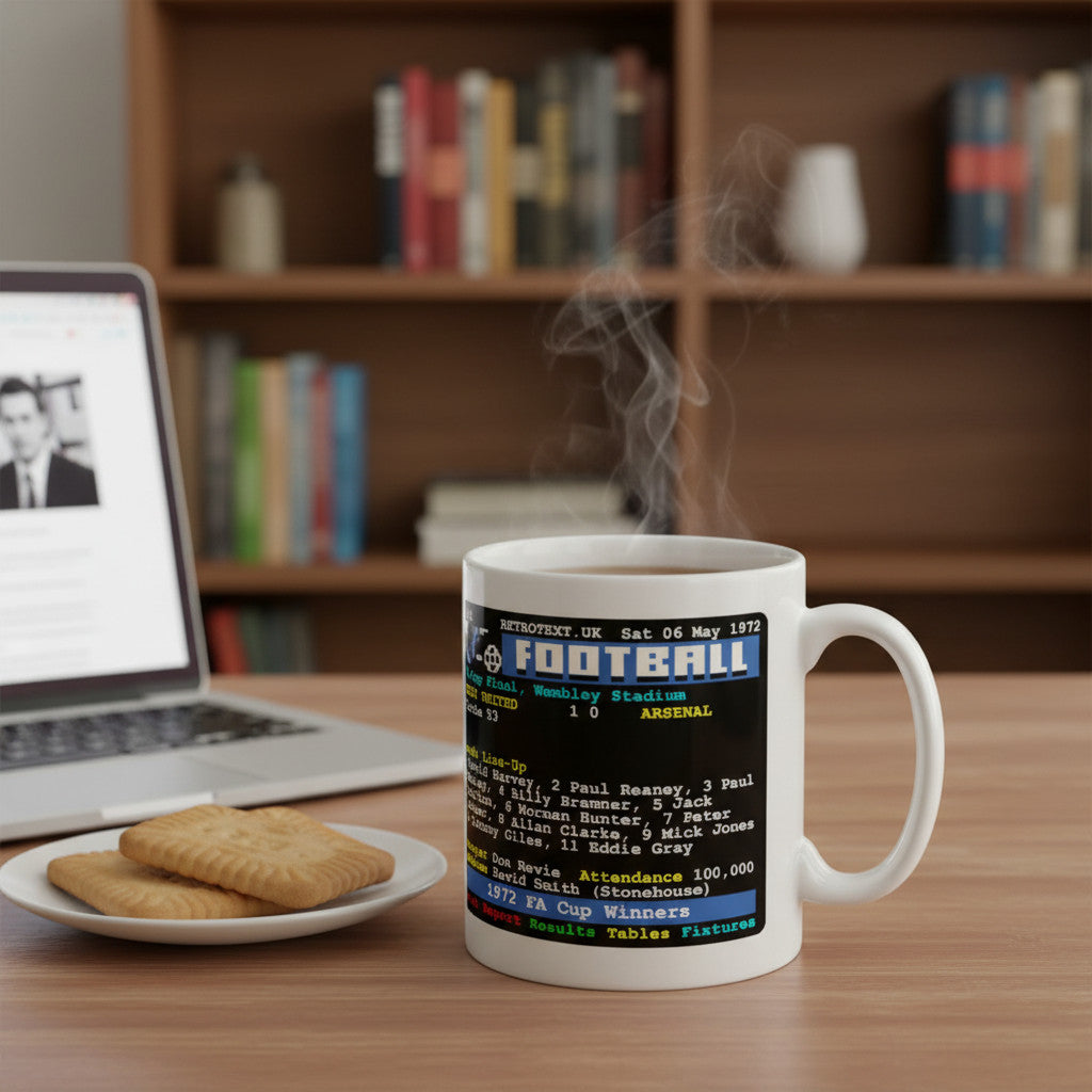 Retrotext Leeds United 1972 FA Cup Winners mug with teletext design on a desk next to a laptop and biscuits