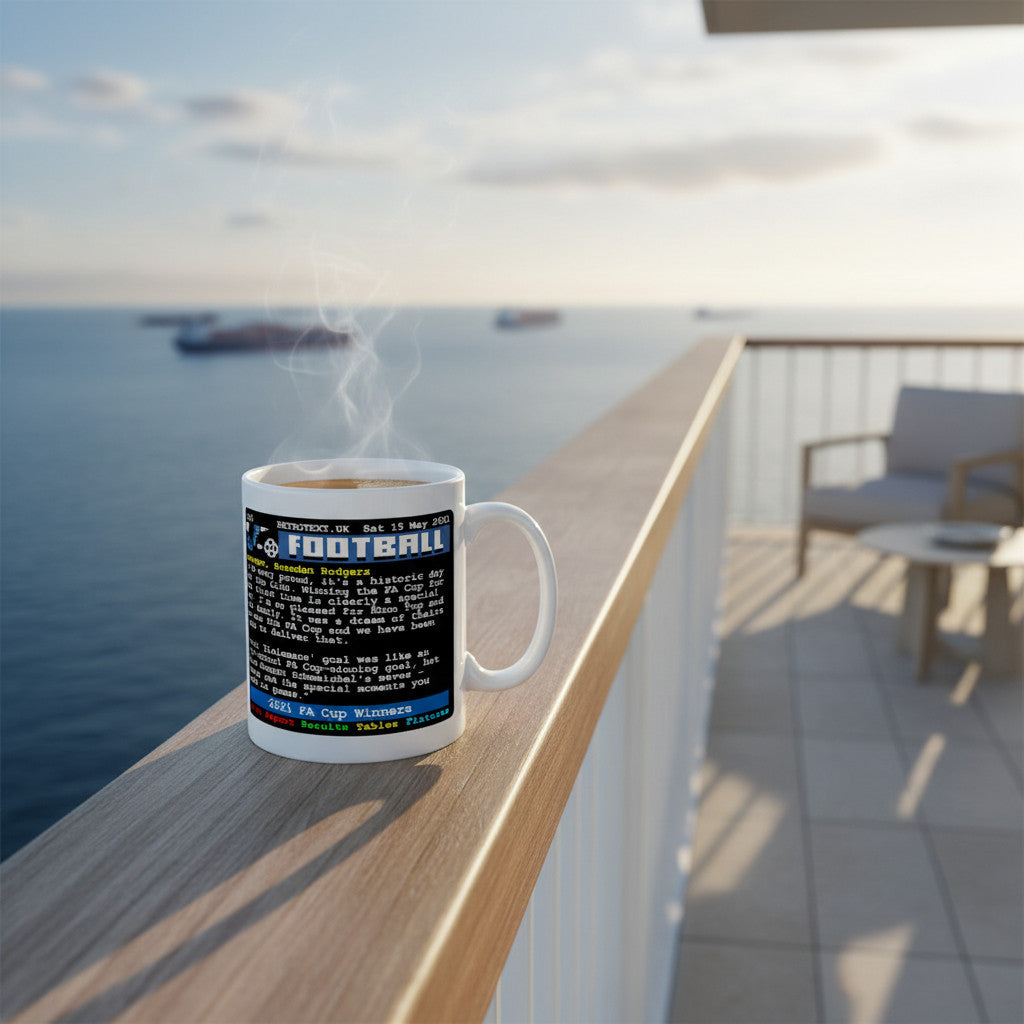 Retrotext Leicester City 2021 FA Cup Winners ceramic mug with retro teletext design on a balcony overlooking the sea.