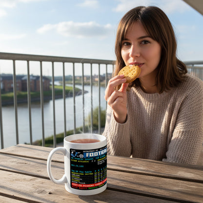 Retrotext Manchester United 2008 Premier League ceramic mug with teletext graphic held by a woman on a balcony