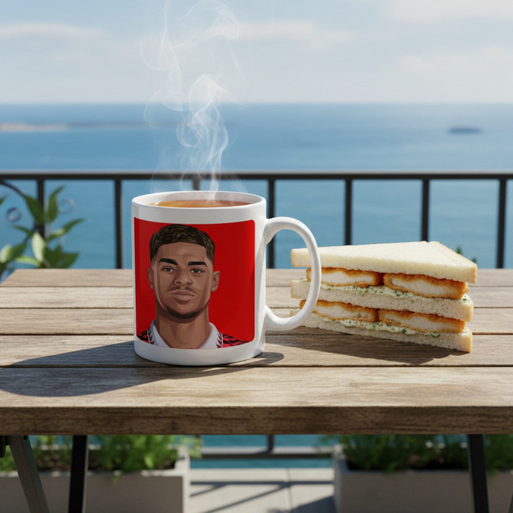 Retrotext ceramic mug featuring a Marcus Rashford illustration on a red background, sitting on a balcony table.