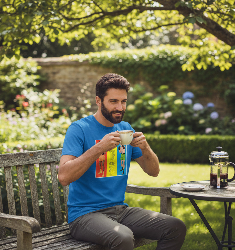 A man wearing a blue Retrotext t-shirt featuring a 1966 Muhammad Ali vs Henry Cooper boxing graphic, sitting outdoors.