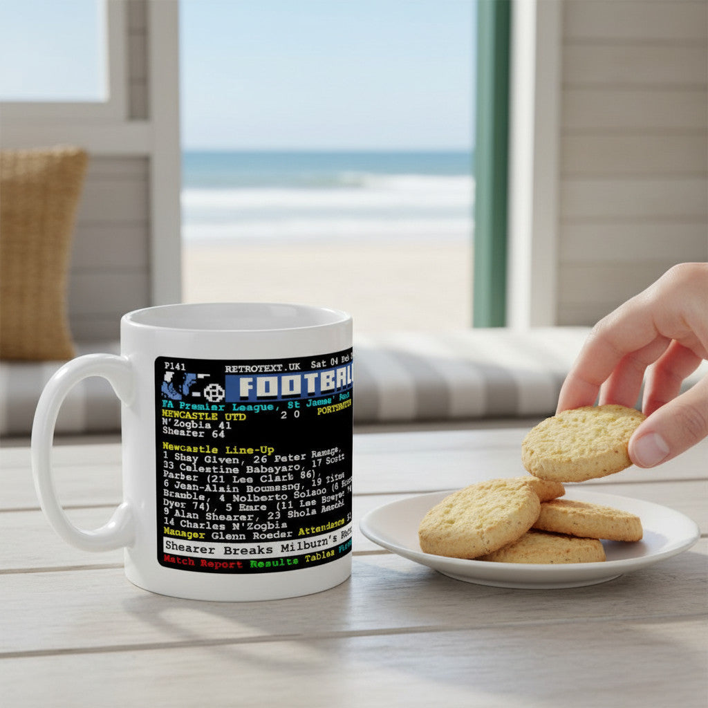 Retrotext Newcastle United 2006 Alan Shearer record-breaking teletext ceramic mug on a wooden table with cookies
