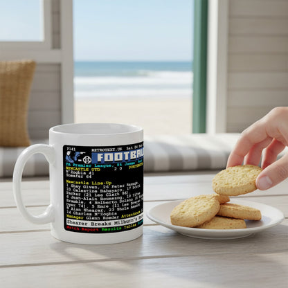Retrotext Newcastle United 2006 Alan Shearer record-breaking teletext ceramic mug on a wooden table with cookies