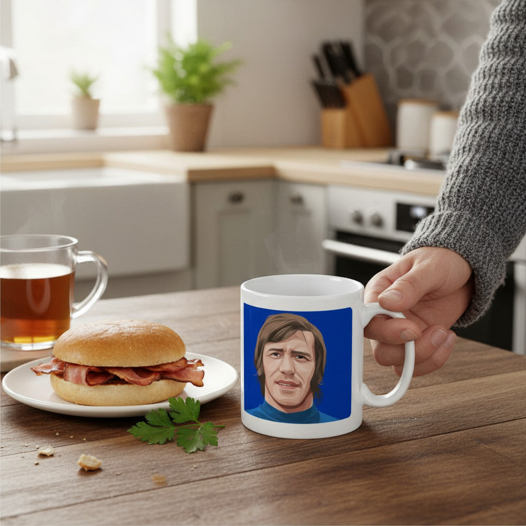 Retrotext Rangers 1972 John Greig ceramic mug featuring a blue teletext-style illustration on a wooden kitchen table.