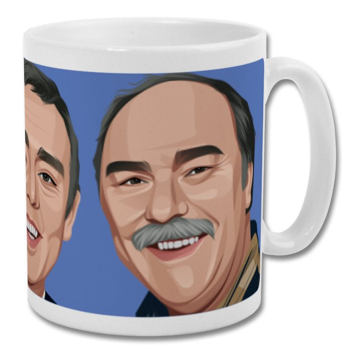 Retrotext Saint and Greavsie 11oz glossy white ceramic mug featuring a blue wraparound illustration of the duo