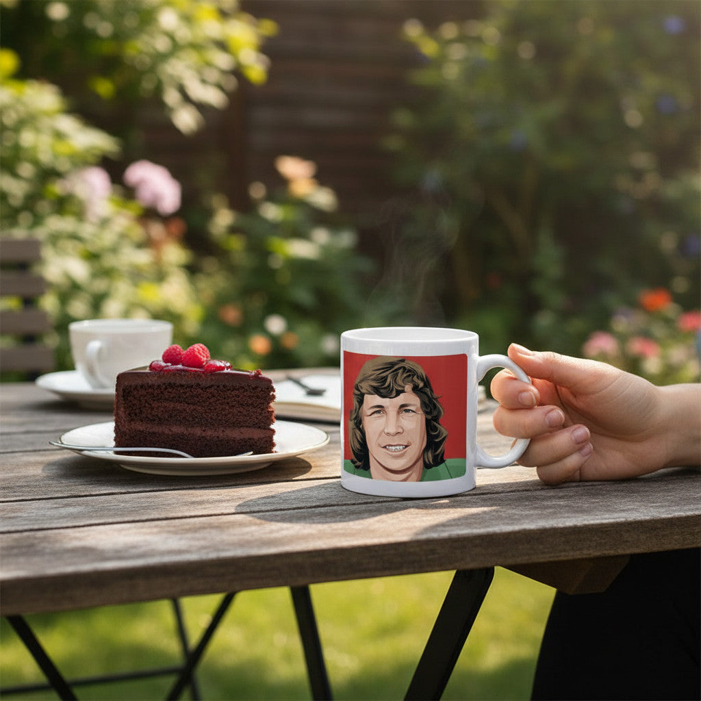 Retrotext white ceramic mug featuring a Jim Montgomery illustration from the 1973 FA Cup final on a garden table.